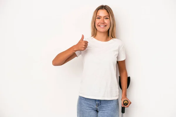 Young Caucasian Woman Holding Crutch Isolated White Background Smiling Raising — Stok fotoğraf
