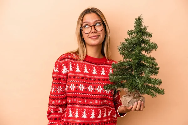 Young Caucasian Woman Holding Little Christmas Tree Isolated Beige Background — Stockfoto
