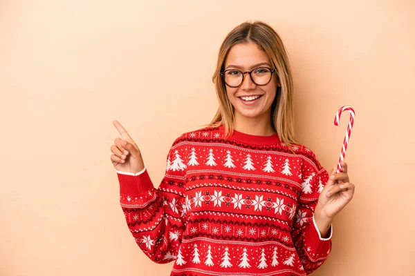 Young Caucasian Woman Holding Christmas Stick Isolated Beige Background Smiling — Stok fotoğraf