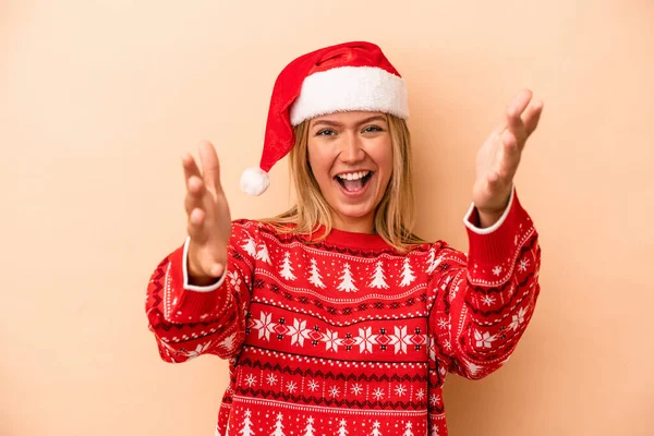 Young Caucasian Woman Celebrating Christmas Isolated Beige Background Receiving Pleasant — Stok fotoğraf