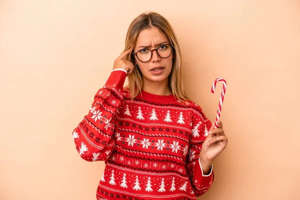 Young Caucasian Woman Holding Christmas Stick Isolated Beige Background Showing — 스톡 사진