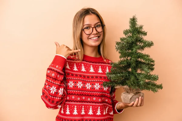 Young Caucasian Woman Holding Little Christmas Tree Isolated Beige Background — Fotografia de Stock
