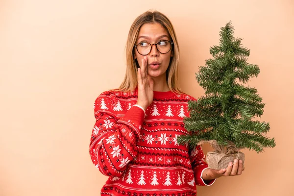 Young Caucasian Woman Holding Little Christmas Tree Isolated Beige Background — Stock fotografie