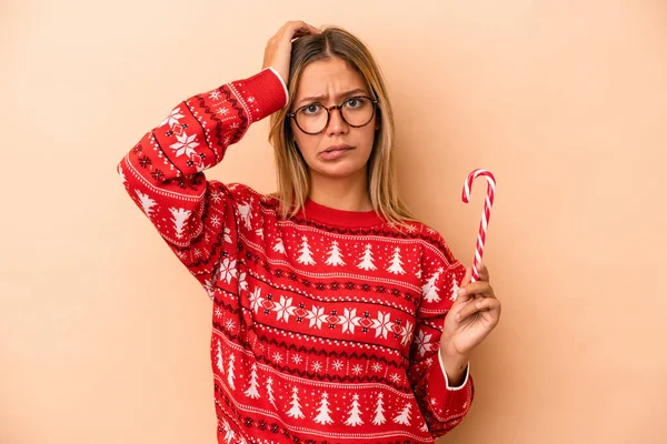 Young Caucasian Woman Holding Christmas Stick Isolated Beige Background Being — Stock Photo, Image