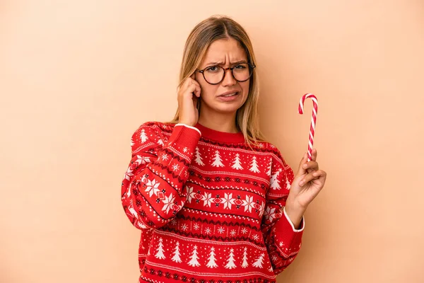 Young Caucasian Woman Holding Christmas Stick Isolated Beige Background Covering — Stok fotoğraf