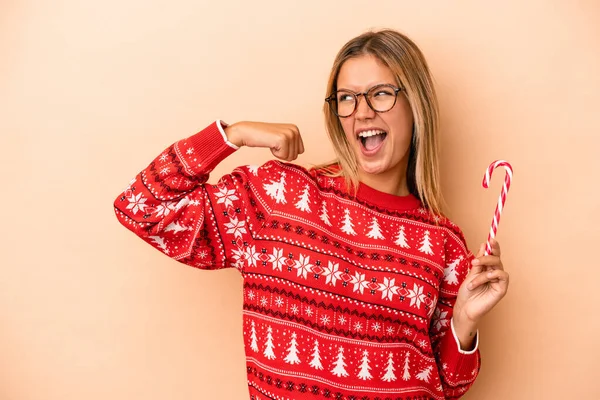 Young Caucasian Woman Holding Christmas Stick Isolated Beige Background Raising — Stok fotoğraf
