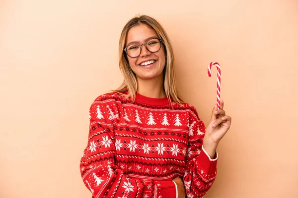 Young Caucasian Woman Holding Christmas Stick Isolated Beige Background Laughing — Stok fotoğraf