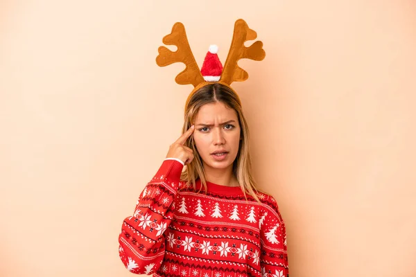 Young Caucasian Woman Wearing Christmas Reindeer Hat Isolated Beige Background — Stok fotoğraf