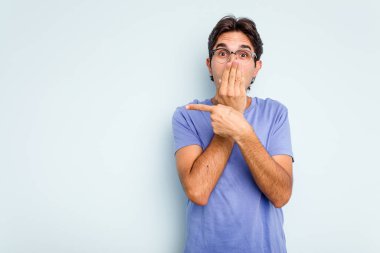 Mavi arka planda izole edilmiş genç bir İspanyol yan tarafı gösteriyor.