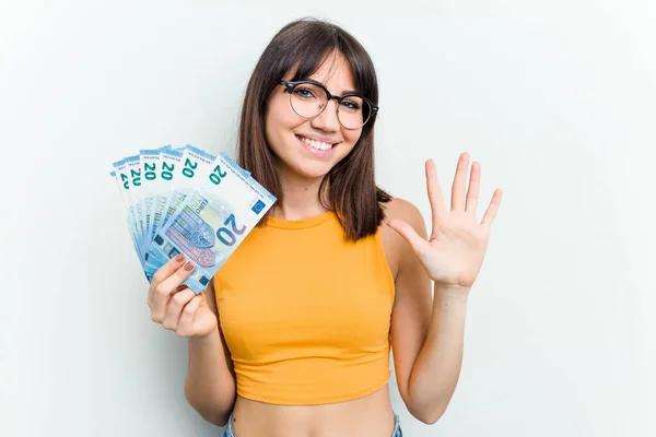 Young Caucasian Woman Holding Banknotes Isolated Blue Background Smiling Cheerful — Stock Photo, Image