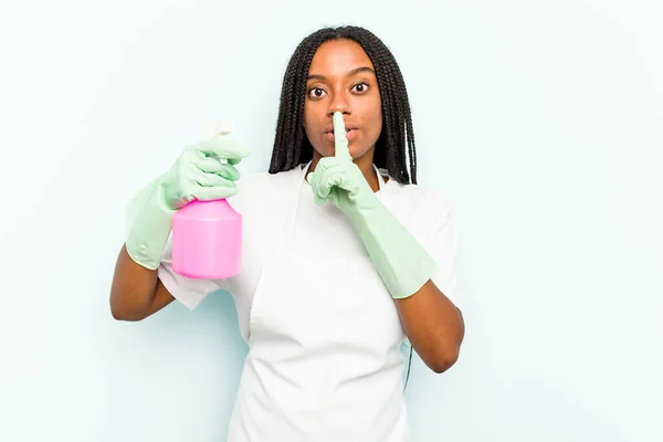 Young African American Cleaner Woman Isolated Blue Background Keeping Secret — Stock Photo, Image