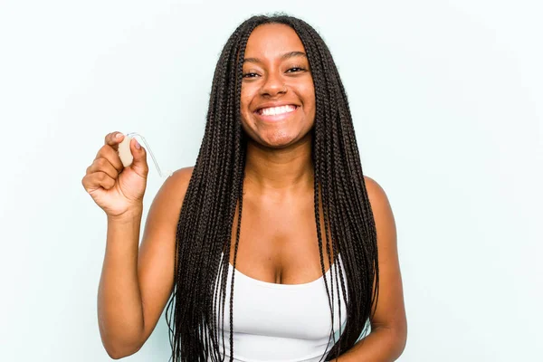 Young African American Woman Holding Hearing Aid Isolated Blue Background — Stock Photo, Image