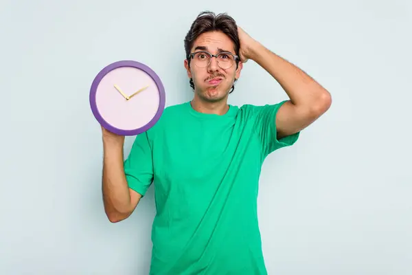 Young Hispanic Man Holding Clock Isolated White Background Being Shocked — Stock Photo, Image