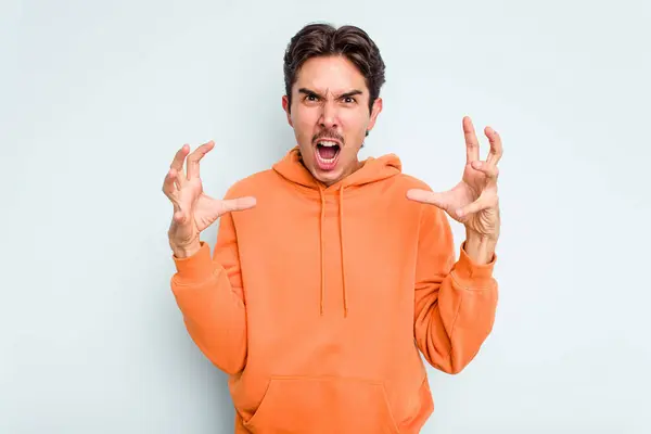 Young Hispanic Man Isolated Blue Background Screaming Rage — стоковое фото