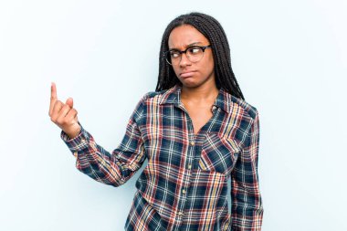 Saçları mavi arka planda izole edilmiş genç Afrikalı Amerikalı kadın sanki seni davet ediyormuş gibi seni işaret ediyor..