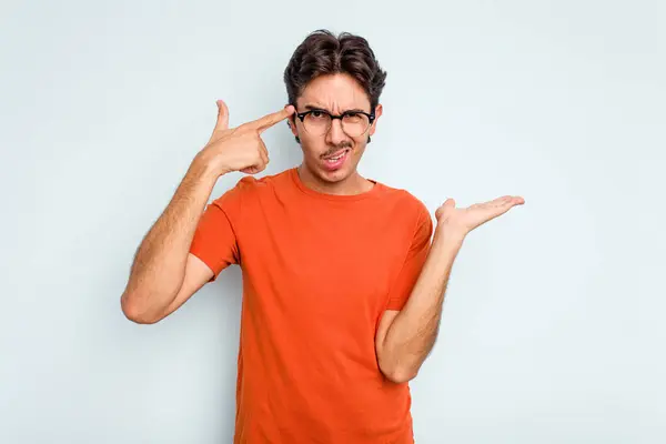 Young Hispanic Man Isolated Blue Background Showing Disappointment Gesture Forefinger — стоковое фото