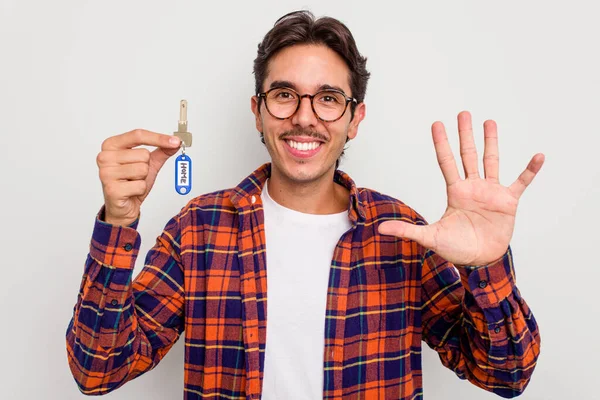 Joven Hispano Sosteniendo Llaves Aisladas Sobre Fondo Blanco Sonriente Alegre —  Fotos de Stock