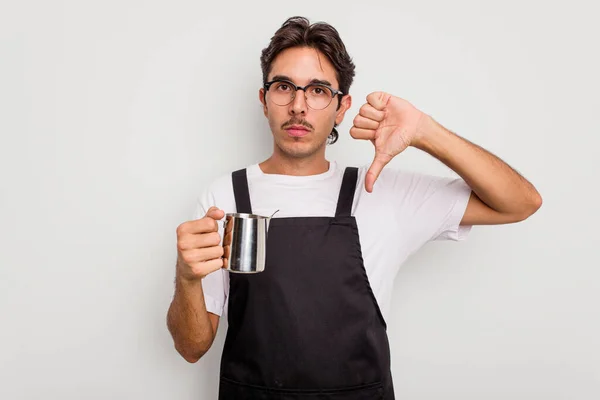 Young hispanic barista man isolated on white background showing a dislike gesture, thumbs down. Disagreement concept.