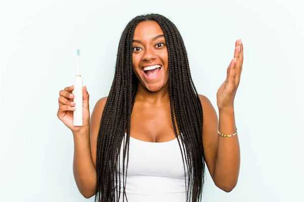 Young African American Woman Holding Electric Toothbrush Isolated Blue Background — Stock Photo, Image