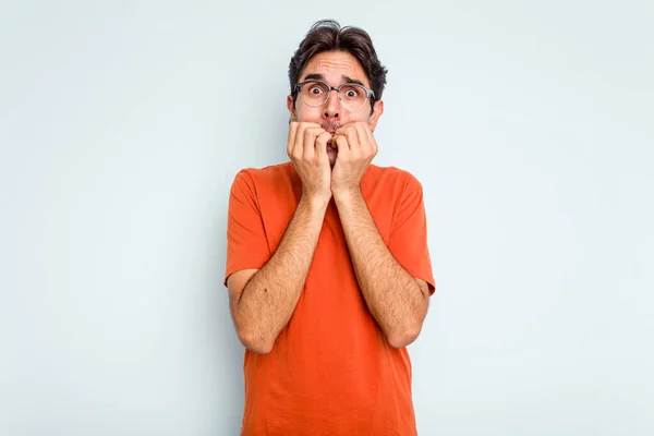 Young Hispanic Man Isolated Blue Background Biting Fingernails Nervous Very — стоковое фото