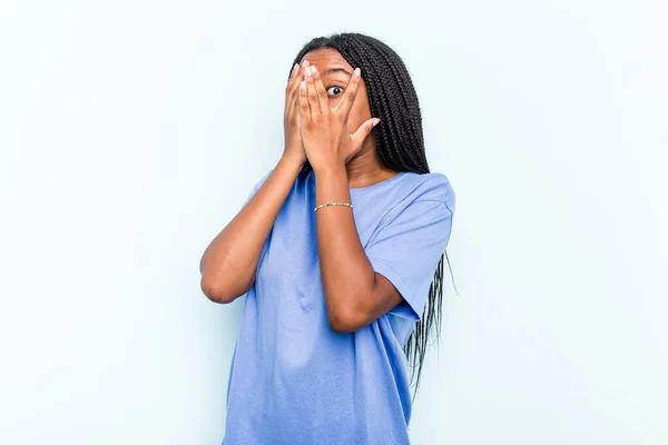 Młoda Afroamerykanka Warkoczami Odizolowana Niebieskim Tle Mruga Przez Palce Przestraszona — Zdjęcie stockowe