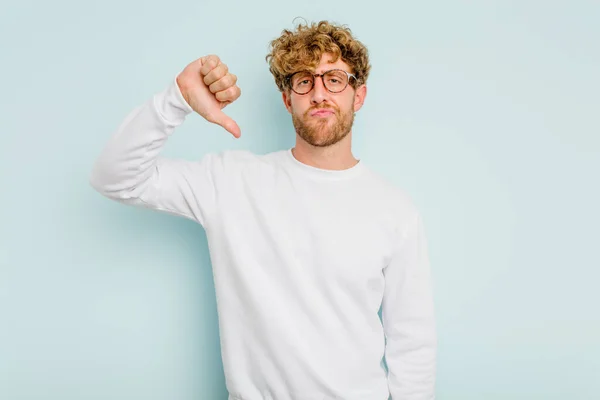 Young Caucasian Man Isolated Blue Background Showing Thumb Disappointment Concept — Stock Photo, Image