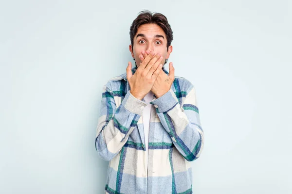Young Hispanic Man Isolated Blue Background Shocked Covering Mouth Hands — стоковое фото