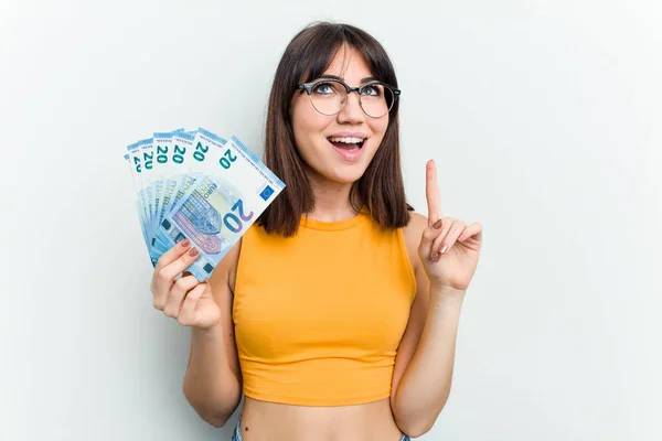 Young Caucasian Woman Holding Banknotes Isolated Blue Background Pointing Upside — Stock Photo, Image
