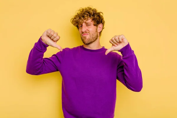 Young Caucasian Man Isolated Yellow Background Showing Thumb Disappointment Concept — Stock Photo, Image