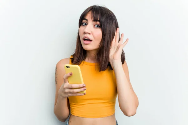 Young Caucasian Woman Using Mobile Phone Isolated White Background Trying — Stock Photo, Image