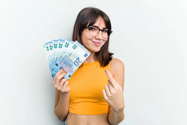 Young Caucasian Woman Holding Banknotes Isolated Blue Background Pointing Finger — Stock Photo, Image