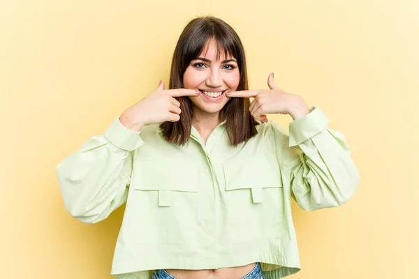 Young Caucasian Woman Isolated Yellow Background Smiles Pointing Fingers Mouth — Stock Photo, Image