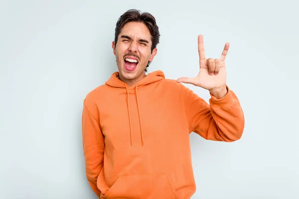 Young Hispanic Man Isolated Blue Background Showing Horns Gesture Revolution — стоковое фото