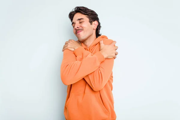 Young Hispanic Man Isolated Blue Background Hugs Smiling Carefree Happy — стоковое фото