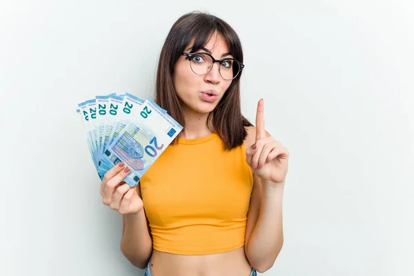 Young Caucasian Woman Holding Banknotes Isolated Blue Background Having Some — Stock Photo, Image