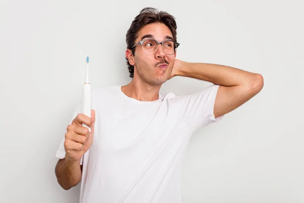 Young Hispanic Man Holding Electric Toothbrush Isolated White Background Touching — Stock Photo, Image