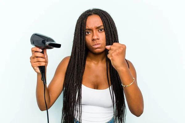 Young African American Woman Holding Hairdryer Isolated Blue Background Showing — Stock Photo, Image