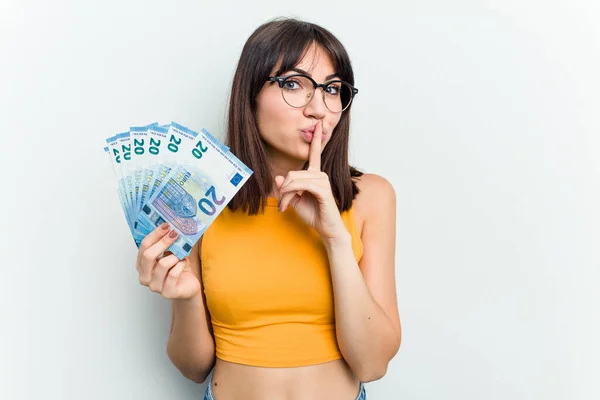 Young Caucasian Woman Holding Banknotes Isolated Blue Background Keeping Secret — Stock Photo, Image