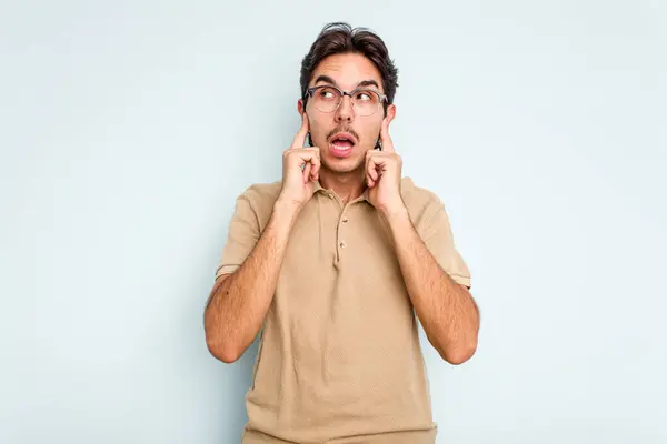 Young Hispanic Man Isolated Blue Background Covering Ears Fingers Stressed — стоковое фото