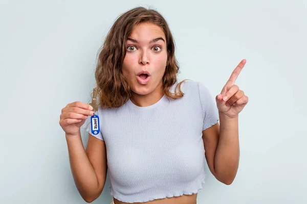 Young Caucasian Woman Holding Home Keys Isolated Blue Background Having — Stockfoto