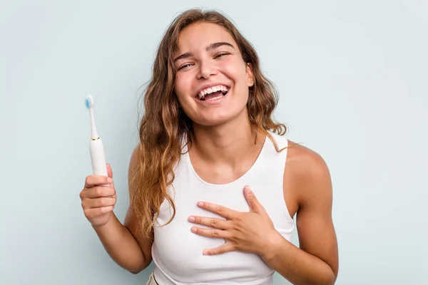 Young Caucasian Woman Holding Electric Toothbrush Isolated Blue Background Laughs — Stock Photo, Image