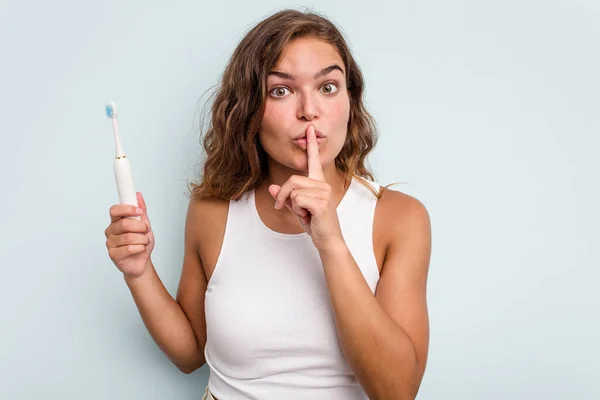 Young Caucasian Woman Holding Electric Toothbrush Isolated Blue Background Keeping — Stock Photo, Image
