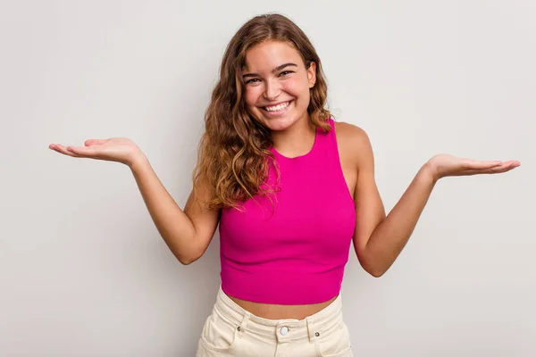 Young Caucasian Woman Isolated Blue Background Makes Scale Arms Feels — Stock Photo, Image