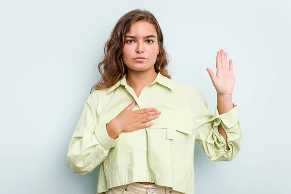 Young Caucasian Woman Isolated Blue Background Taking Oath Putting Hand — Stock Photo, Image