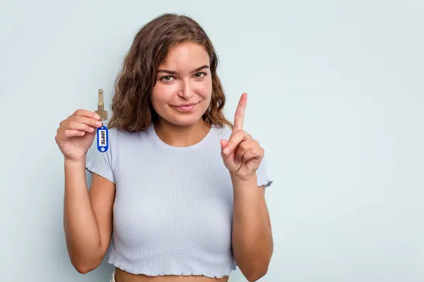 Young Caucasian Woman Holding Home Keys Isolated Blue Background Showing — 图库照片