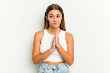 Genç Hintli kadın beyaz arka planda izole edilmiş dua ediyor, bağlılık gösteriyor, dindar biri ilahi ilhamı arıyor..