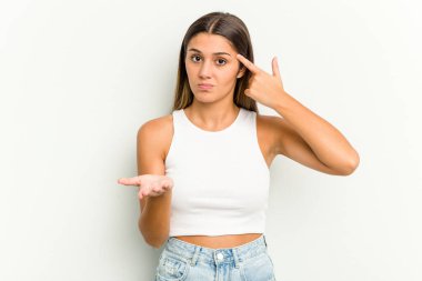 Genç Hintli kadın beyaz arka planda izole edilmiş ve elinde bir ürün tutuyor..