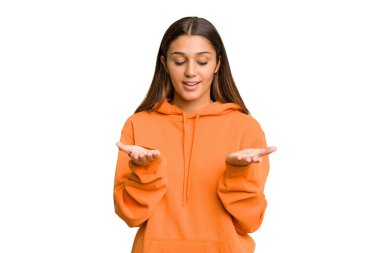 Genç Hintli kadın kesme arkaplanını izole etti. Elinde avuç içi olan bir şey vardı. Kameraya sunuyordu..