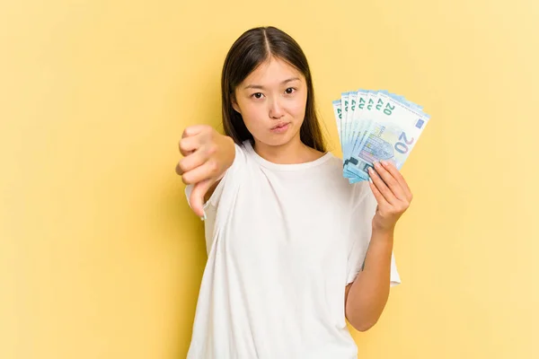 Young Asian Woman Holding Banknotes Isolated Yellow Background Showing Dislike — Stock Photo, Image