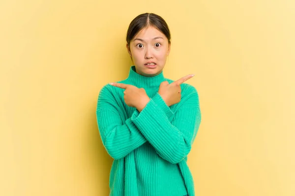 Giovane Donna Asiatica Isolata Punti Sfondo Giallo Lateralmente Sta Cercando — Foto Stock